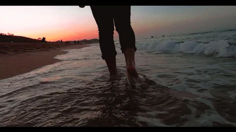 Amazin sunset with a man walking on the beach Video stock 157286309
