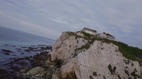 Amazing aerial drone shot past cliffside property to reveal natural cliffs Stock Footage