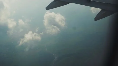 Amazing aerial view above clouds from airplane window with blue sky landscape Stock Footage 138633693