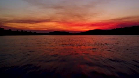 Amazing aerial view of dramatic sunset above the water Stock Footage 149009597