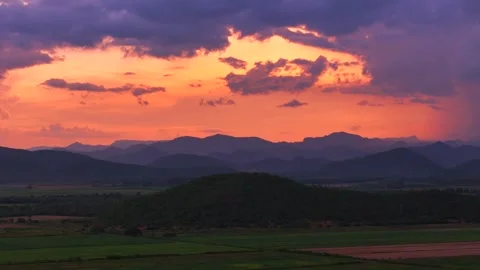 Amazing Aerial view of sunset clouds glowing in warm tones above mountains and 스톡 동영상 314415267