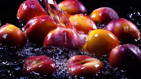 Amazing bathing for fresh nectarines and flat peaches, laying in shallow water Video stock 78352734
