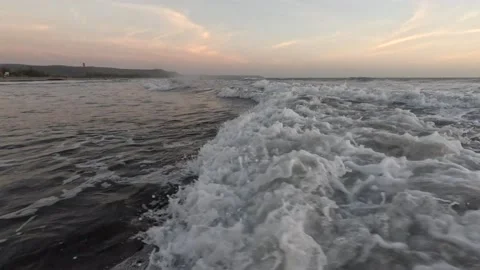 Amazing beach at sunset with waves in the ocean at the beach in the evening Stock Footage 237143061