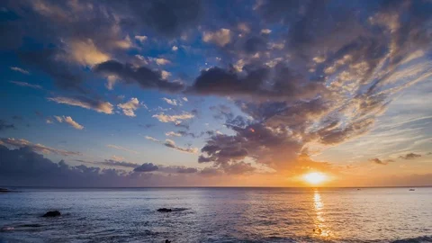Amazing beautiful sunset reflection on the sea with rock, wave and mountain Stock-Footage 100737384