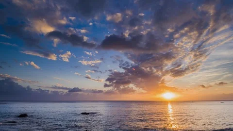 Amazing beautiful sunset reflection on the sea with rock, wave and mountain Stock-Footage 100737387