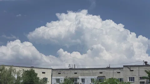 Amazing big clouds fly over high-rise buildings. Swallows fly around. Stock Footage 110795885