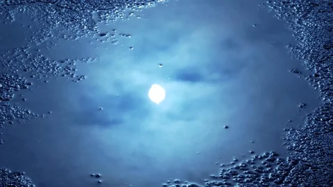 Amazing Black Sun Reflection in Waterpuddle Texture 4K Video Resource Stock Footage 75077249