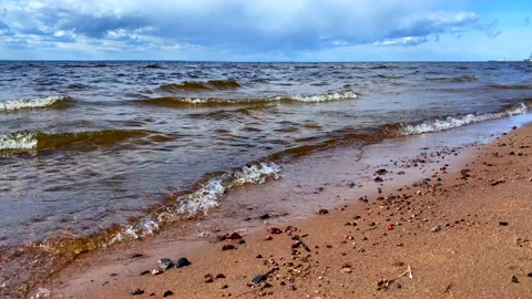 Amazing blue sea with small waves running onto wet sand Stock-Footage 130435652