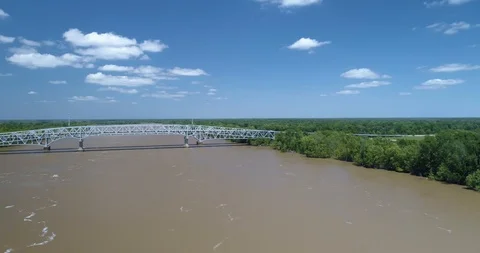 Amazing bridge going across large fast flowing river drone aerial 4K Stock Footage 111363652