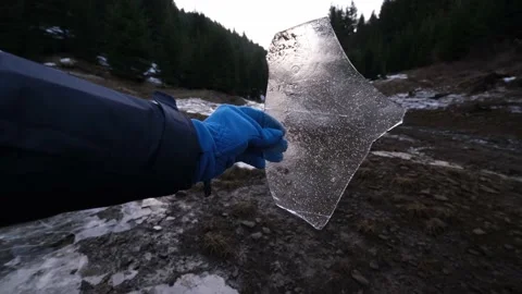 Amazing, broken, transparent and sharp ice piece on a cloudy winter afternoon Stock Footage 151075130