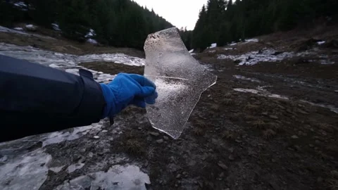 Amazing, broken, transparent and sharp ice piece on a cloudy winter afternoon Stock Footage 151075277