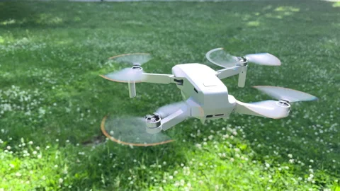 Amazing Closeup Shot of Drone Hovering in Windy Green Park in Daylight Sunlight Stock Footage 311936574