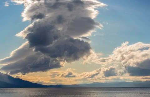 Amazing cloud over the water. Stock Photos