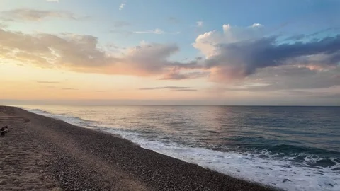 Amazing cloudscape and sea view on empty beach during sunrise, 4K Stock Footage 277109850
