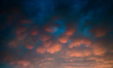 Amazing cloudscape of stormy weather with dramatic mammatus clouds Stock Photos