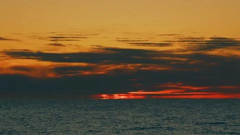 Amazing Colors Sun Setting Down Over The Ocean. Variety Of Colors And Hues Of Stock Photos