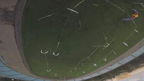 Amazing control of an FPV drone, flying over the racing course and doing tricks Stock Footage 139609061