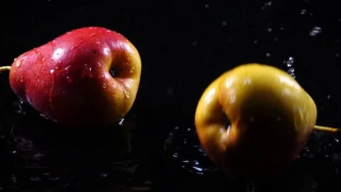 Amazing couple of Forella pears, falling on black surface with shallow water Stock-Footage 78353657
