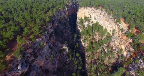 Amazing Deep Crack Inside Pine Forest at Sunset 4k Drone Shot Stock Footage 147084336