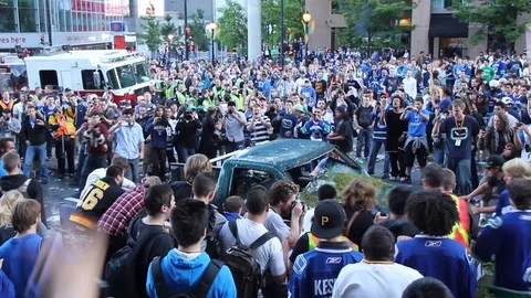 Amazing display of stupidity when crowd flips truck on its side during riot Stock Footage 127202496
