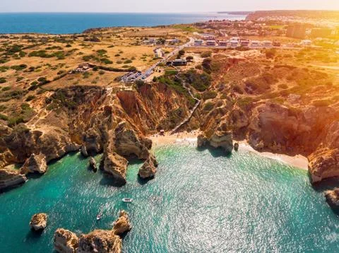 Amazing drone view of orange cliff and turquoise sea, Algarve.  Stock Photos