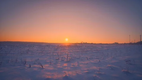 Amazing empty winter field illuminating at beautiful yellow sunset or sunrise Vídeos de archivo 101461800