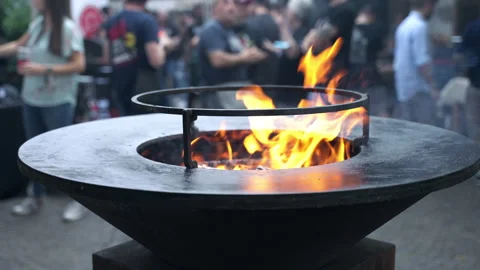 Amazing fire burning inside the black round barbecue smoker, blurred people on Stock-Footage 164601936