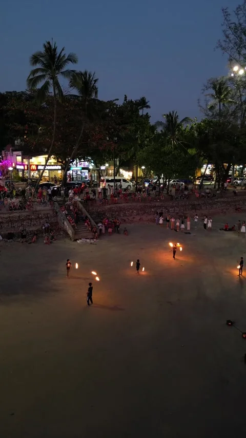 Amazing Fire Dancers Performing on a Crowded Tropical Beach at Night in Ao Nang, Stock Footage 335816574