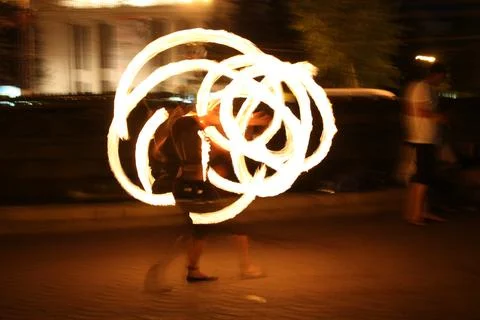 Amazing fire show performance with light trails at night Фото