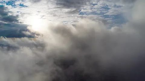 Amazing flight through moving clouds towards bright shining sun. Stock Footage 150518987