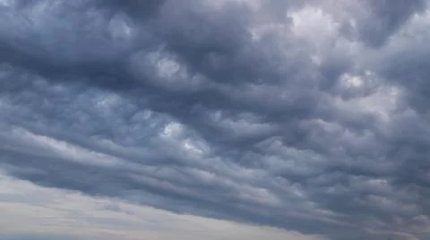 Amazing fluffy clouds floating the sky going to darkness Stock Photos