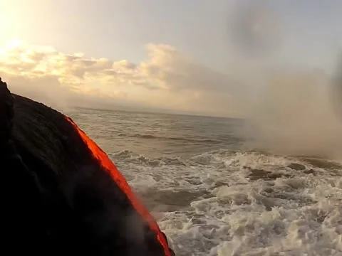 Amazing footage of lava creating a black sand beach Stock Footage