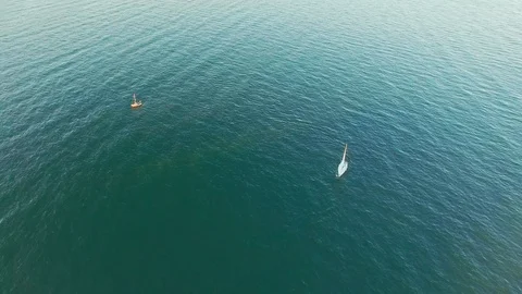 Amazing high angle aerial view of sail yacht sailing at sea shot from a drone. Stock Footage 107811248