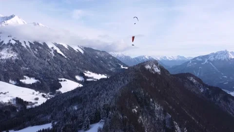 Amazing high angle top drone view. Skier paragliding above ski resort winter Stock Footage 194568616