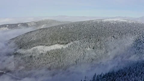 Amazing inversion clouds in mountains ridges with foggy forest trees in sunset Stock Footage 141929620