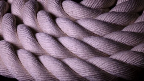 Amazing isolated white cable in flat roll close up, rotating in shadow Stock Footage 84113103