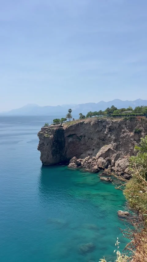 Amazing landscape with a cliff with small waterfall by the coast Stock Footage 337033004