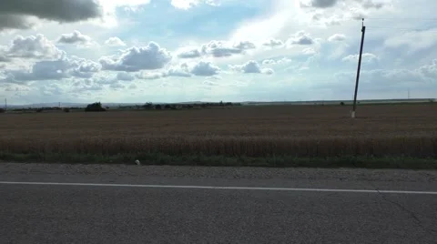 Amazing Landscape With Cloudy Sky, Field and Road in Countryside Stock Footage 64765193