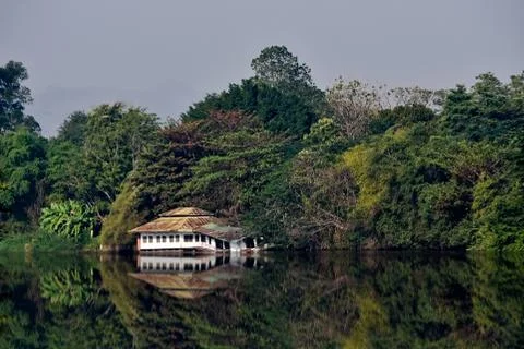 Amazing landscape with reflection. Old floating house in the jungle at the ri Stock Photos
