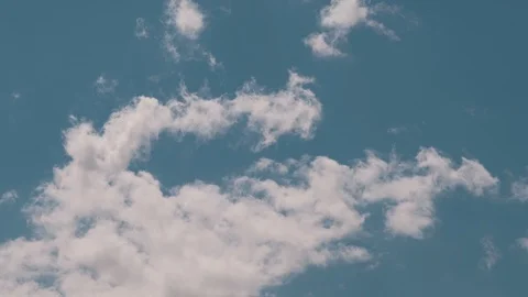 Amazing light volumetric clouds fly quickly and dissolve in the blue sky Stock Footage 128960691