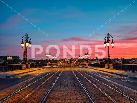 Amazing low angle view of the Bordeaux Stone Bridge and amazing sunset sky over Stock Photos