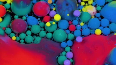 Amazing multicolored bubbles of paint on the oil surface. Paint in oil. Stock Footage 105178010