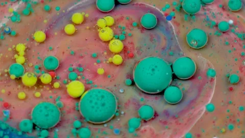 Amazing multicolored bubbles of paint on the oil surface. Paint in oil. Stockbeeldmateriaal 106522010
