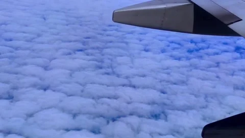 Amazing nature of altocumulus clouds through an airplane window. 4K sky Stock Footage 256059273