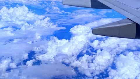 Amazing nature of clouds through an airplane window. 4K Sky Stock Footage 256059249
