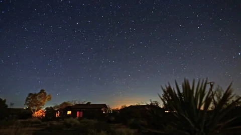 Amazing night sky stars over desert cabin time-lapse as sun rises Stock Footage