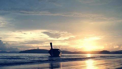 Amazing ocean landscape with sun setting over tropical beach and lonly long tail Stock Footage 86017089