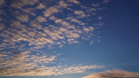 Amazing orange clouds fly in the blue sky Stock Footage 107850710