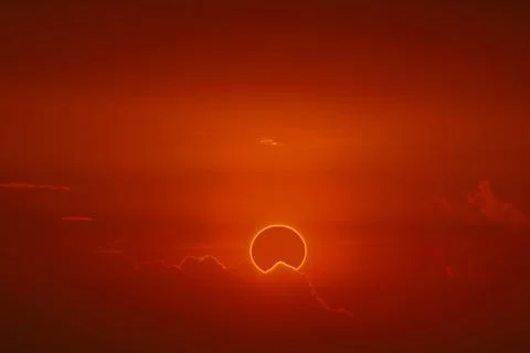 Amazing phenomenon of total sun eclipse over cloud sunset red orange sky on t 写真素材