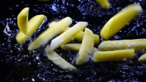 Amazing raw julienne potatoes, falling on black surface with shallow water Stock-Footage 77730586